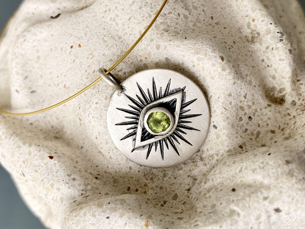 Evil eye necklace silver with a green gemstone 