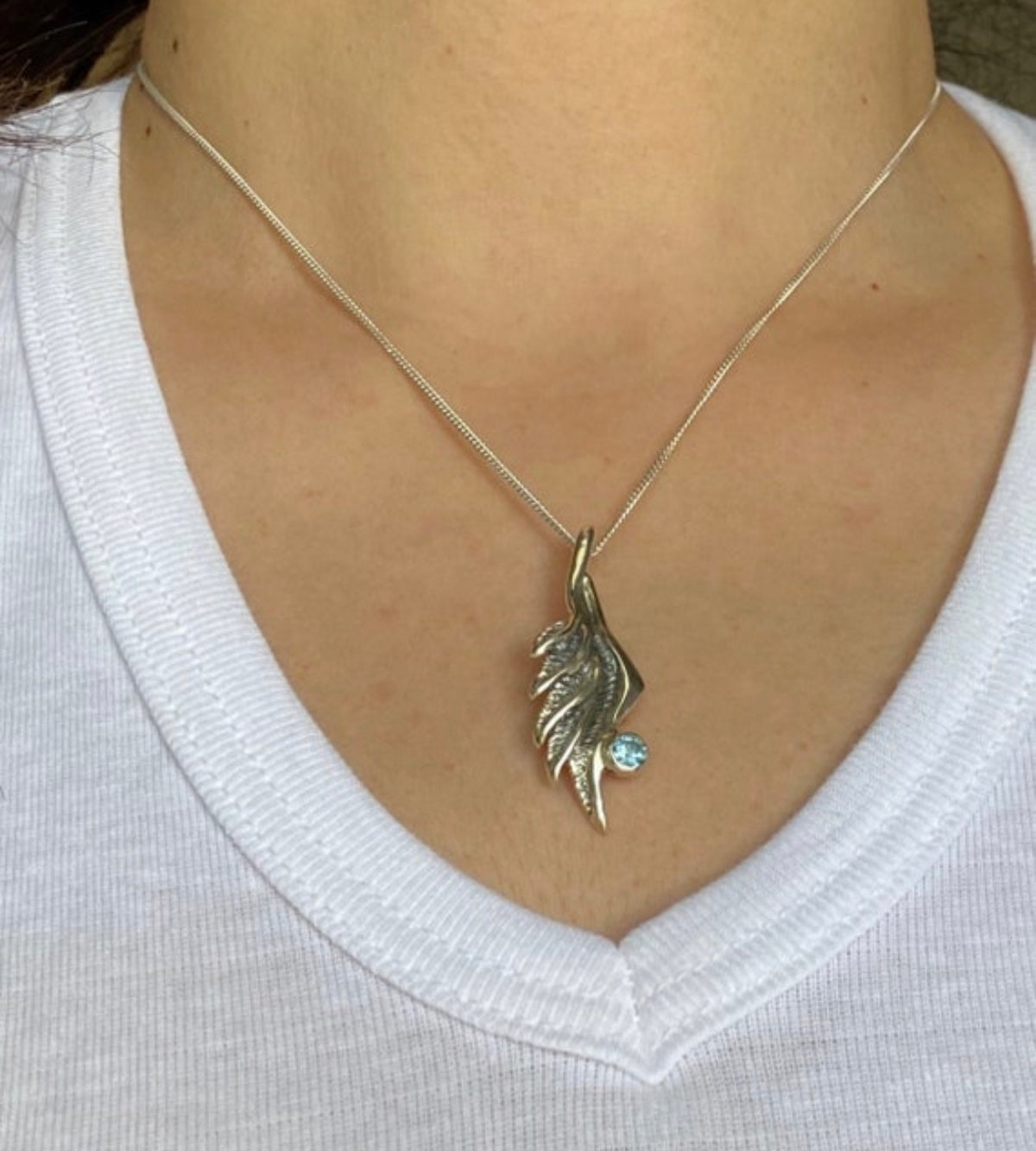 angel wing necklace with blue topaz