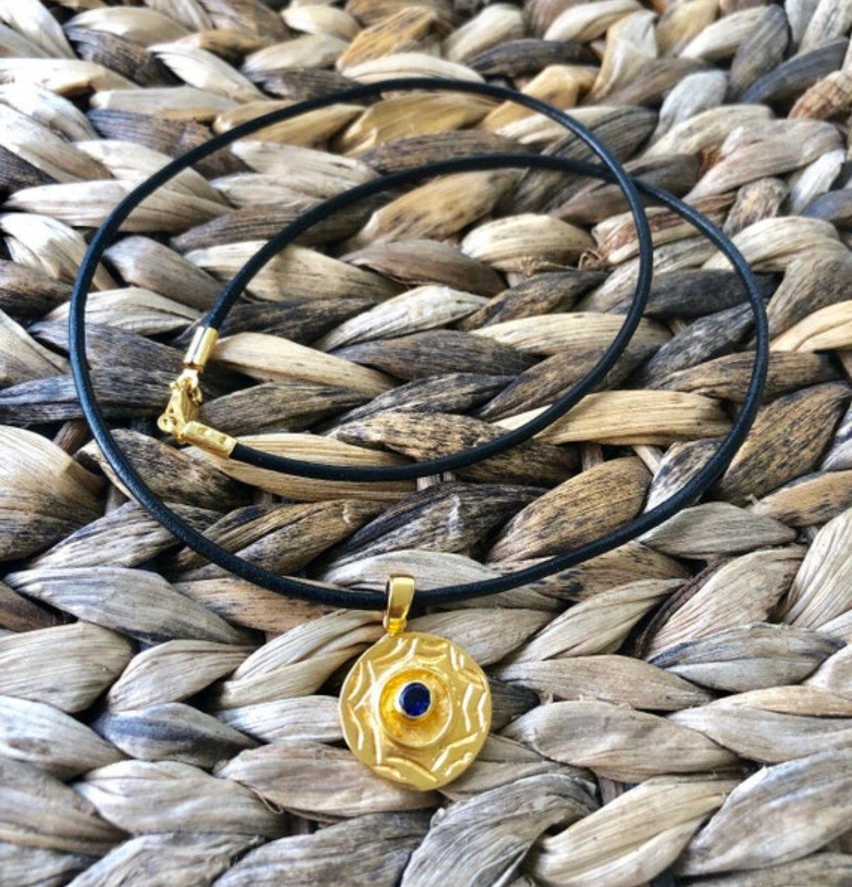 gold evil eye necklace with iolite gemstone