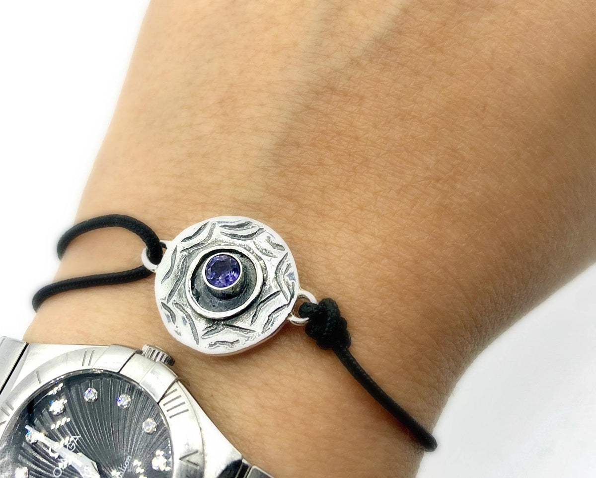 circle evil eye bracelet silver with a blue iolite