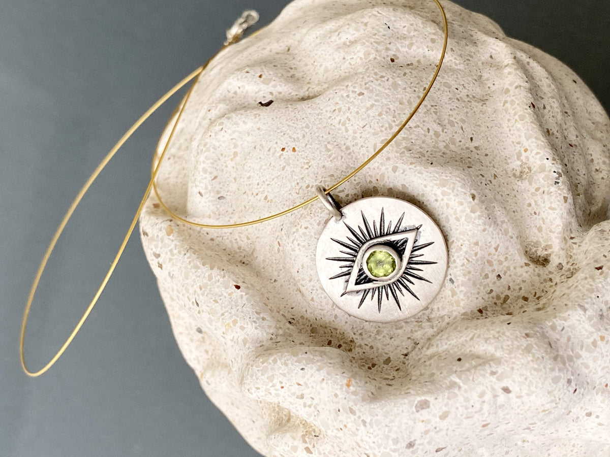 Evil eye necklace silver with a green gemstone 