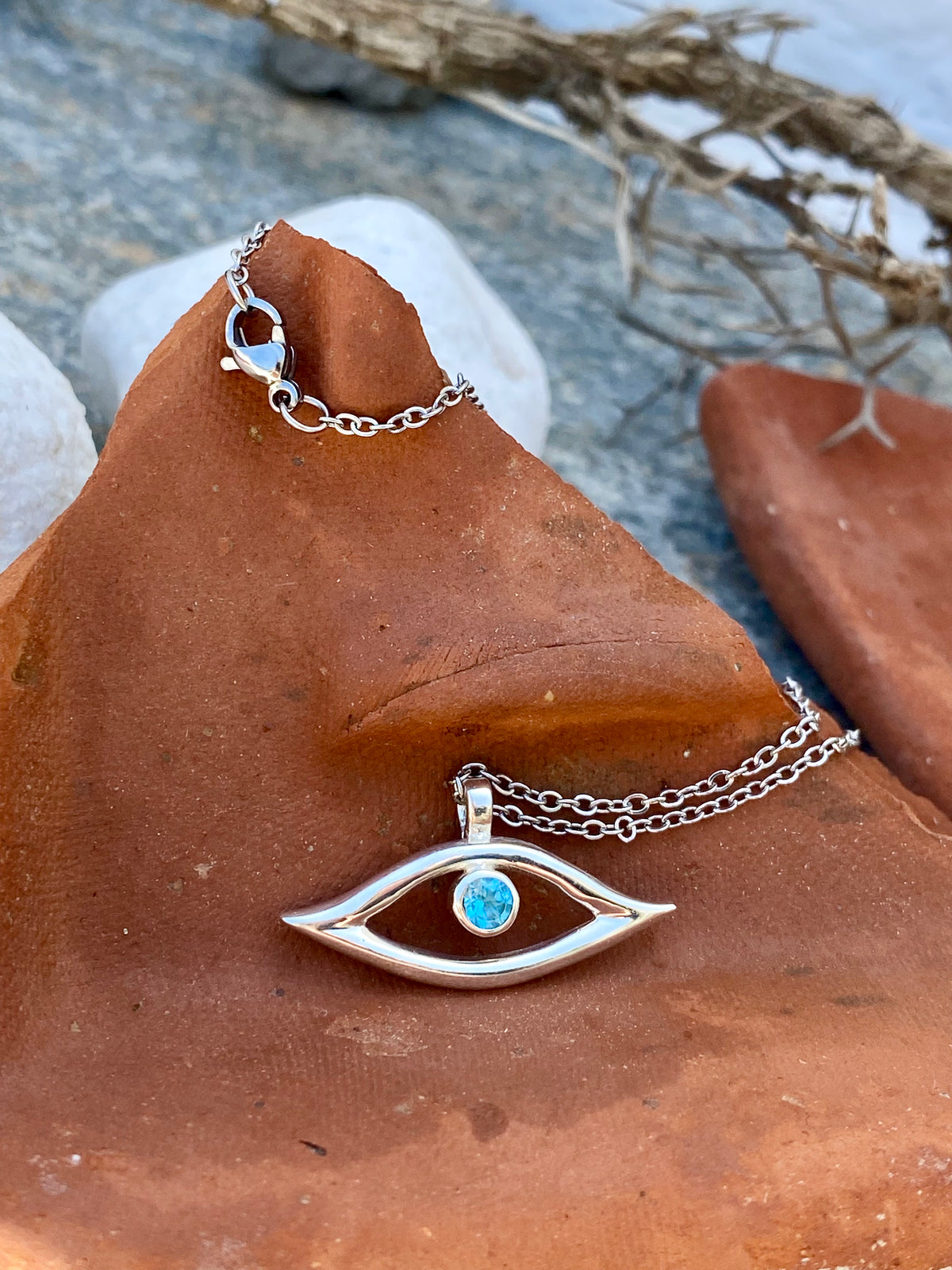 evil eye necklace with blue topaz gemstone