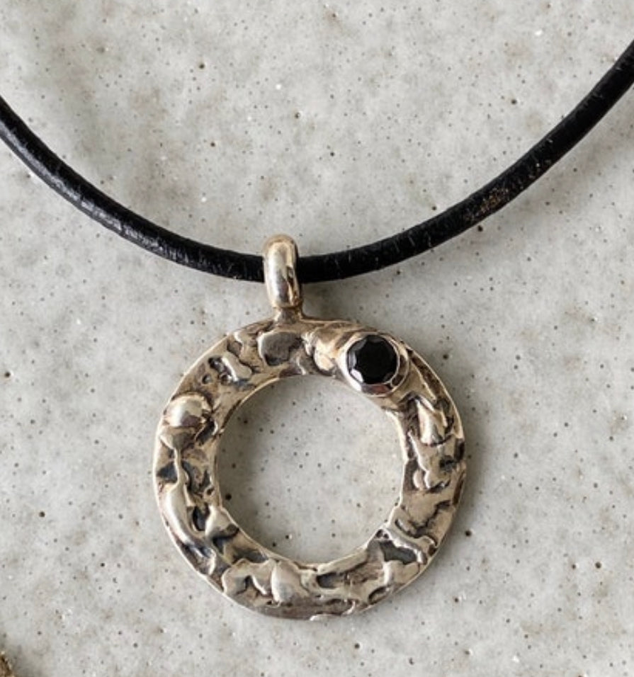 handmade circle necklace with a black gemstone