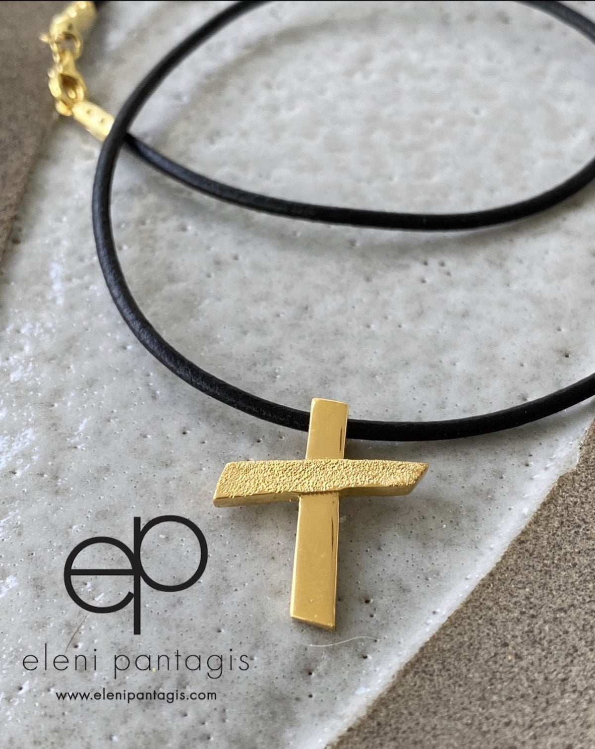 gold cross with black leather necklace