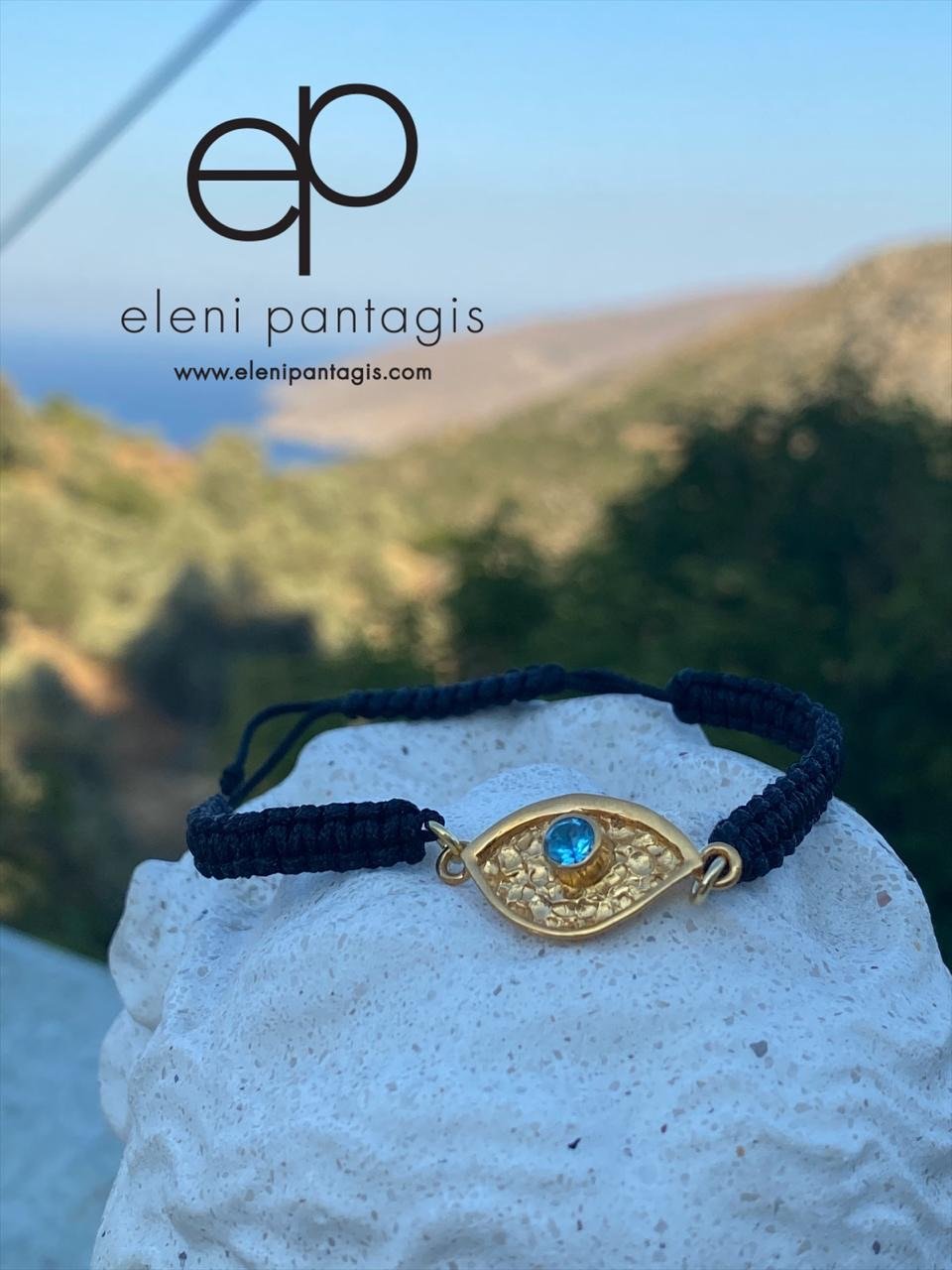 a gold evil eye handmade bracelet with a blue gemstone