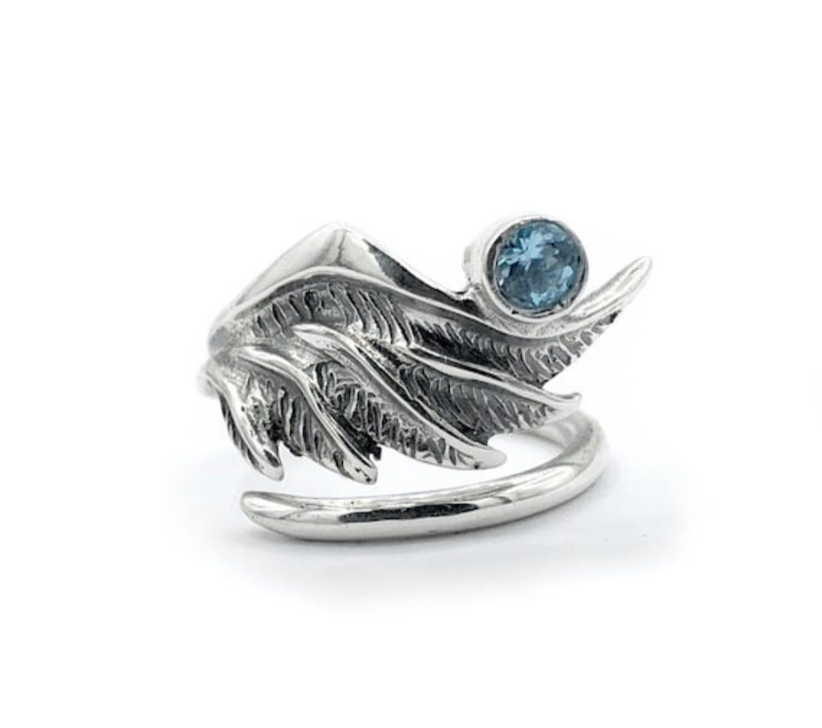 silver angel wing with a blue topaz