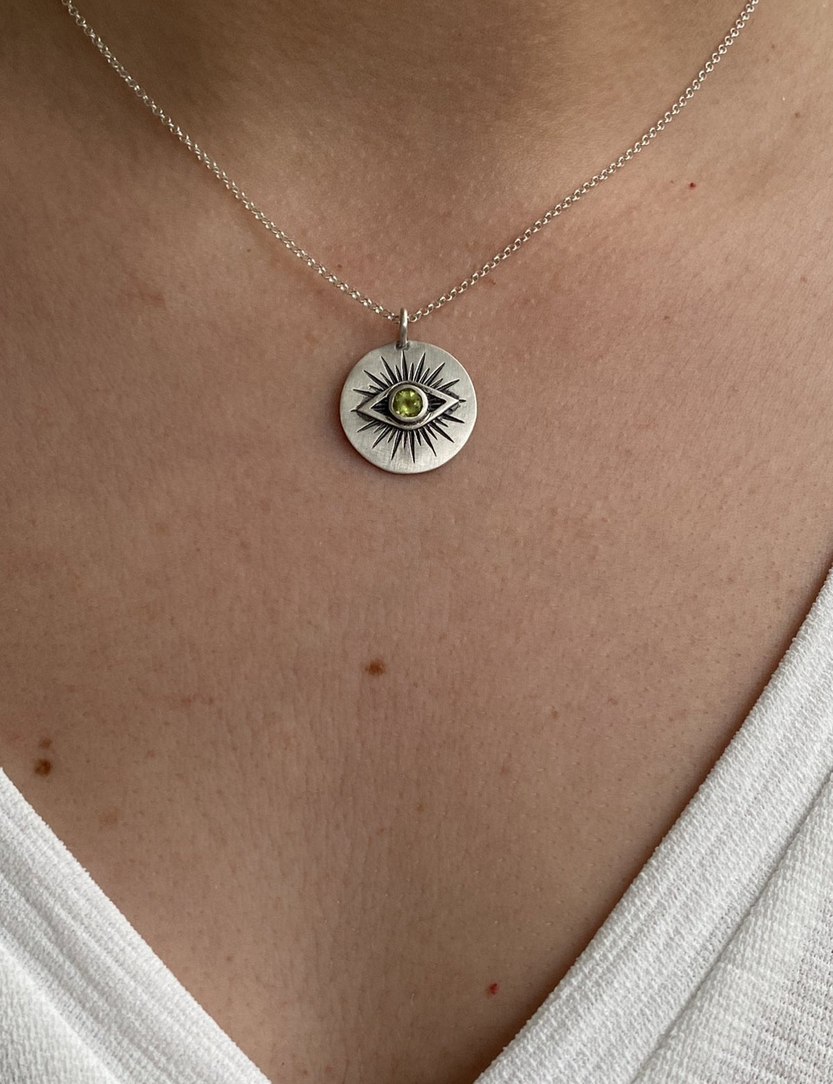 Evil eye necklace silver with a green gemstone 