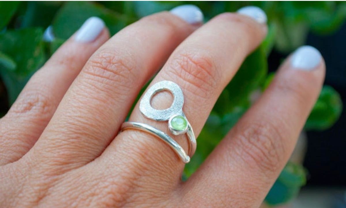 silver open circle ring with a peridot gemstone