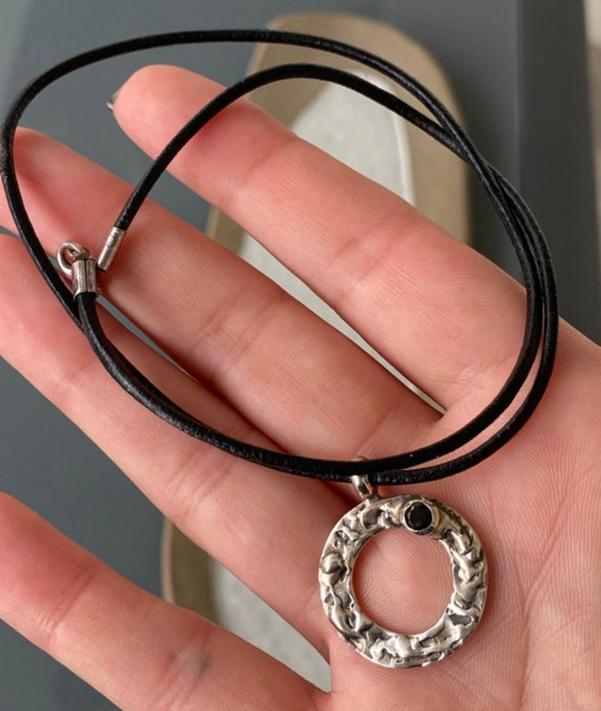 handmade circle necklace with a black gemstone