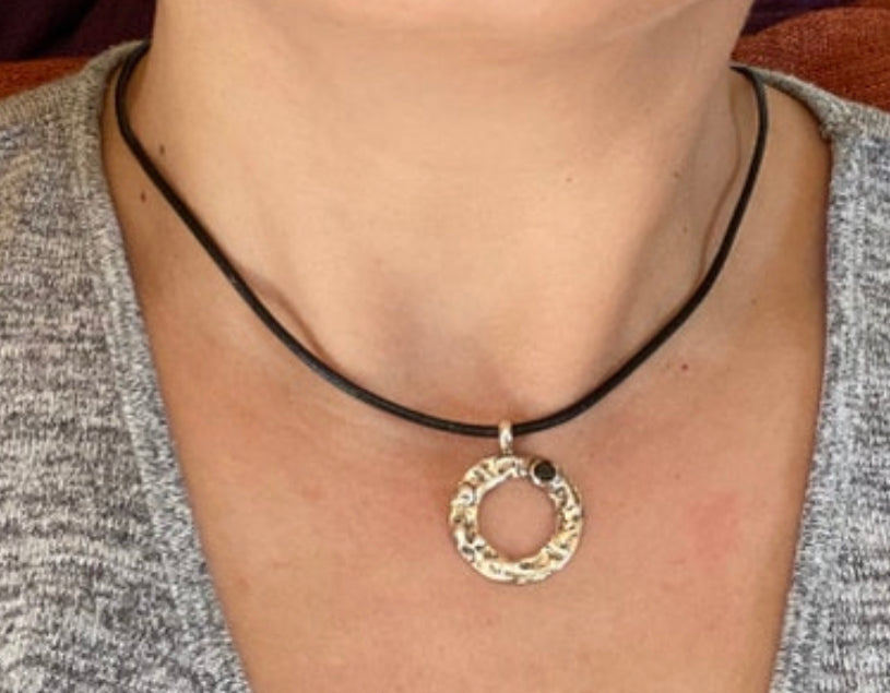 handmade circle necklace with a black gemstone