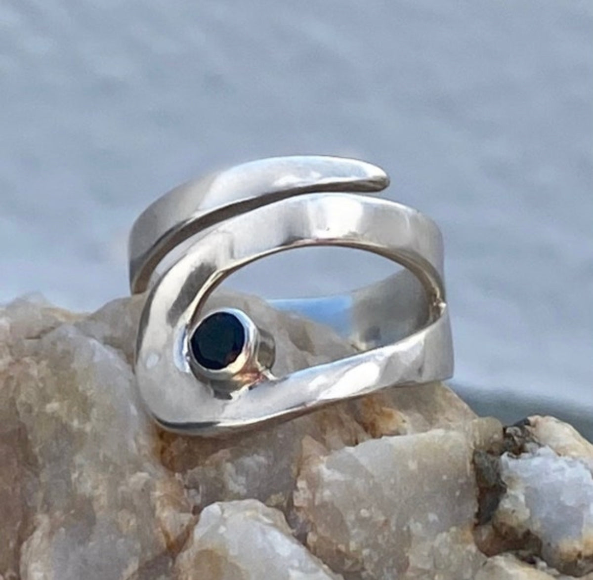 silver ring with black gemstone