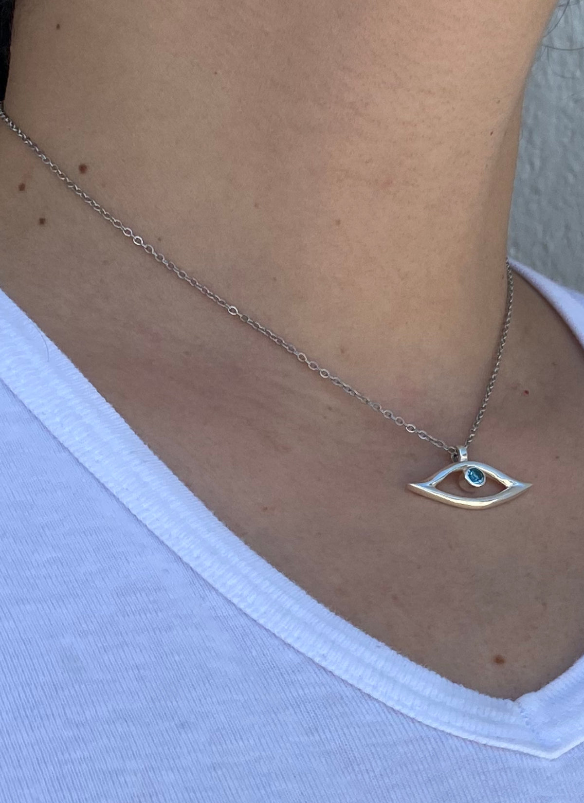 evil eye necklace with blue topaz gemstone