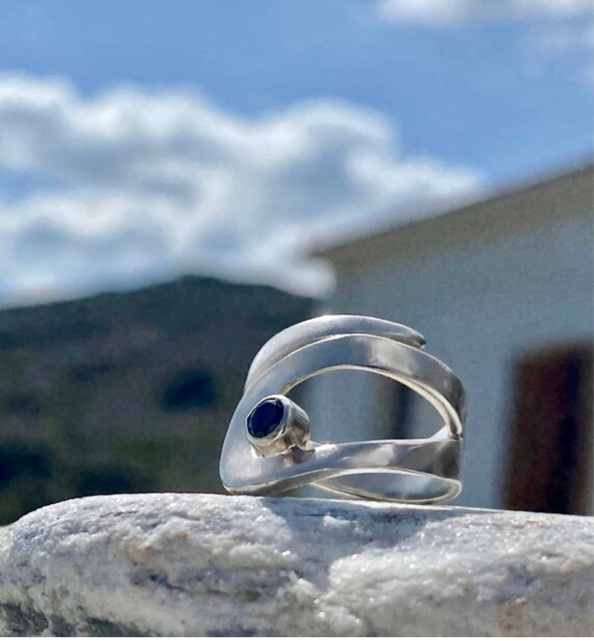 silver ring with black gemstone