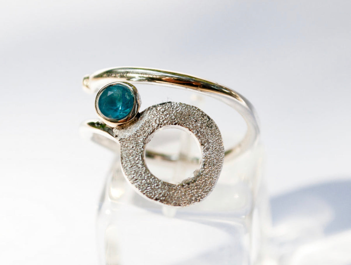 silver circle ring with blue topaz gemstone