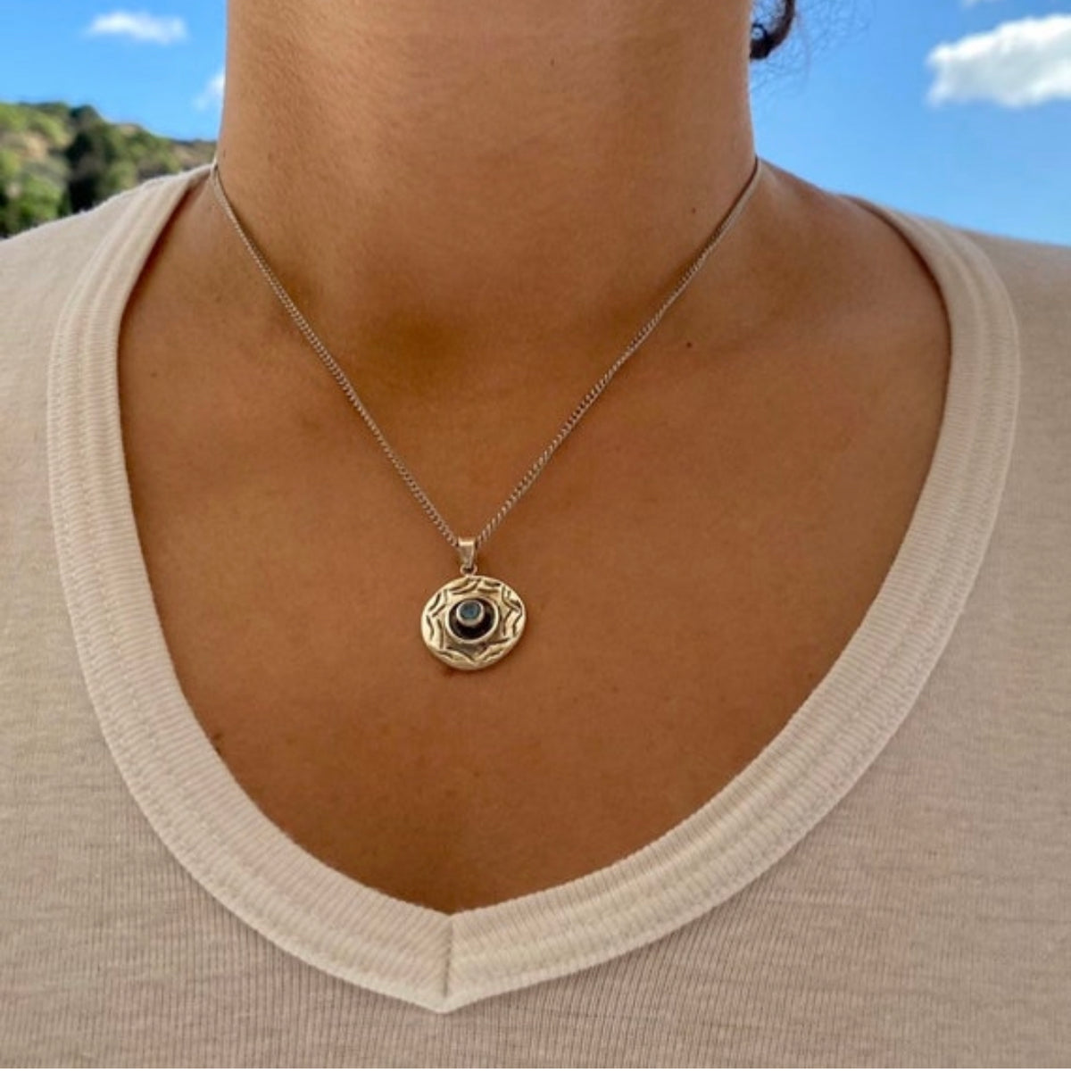 round evil eye necklace with blue topaz