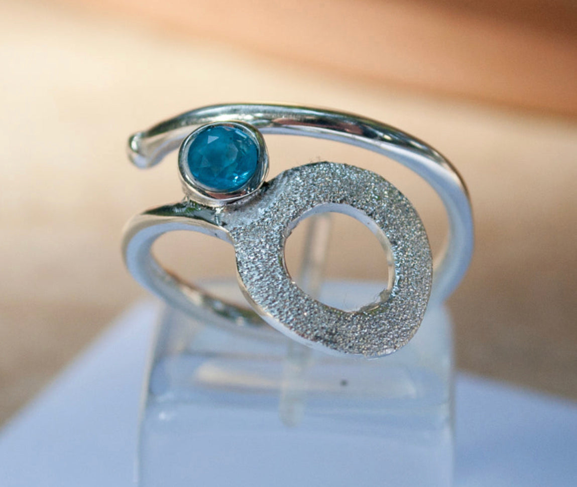 silver circle ring with blue topaz gemstone