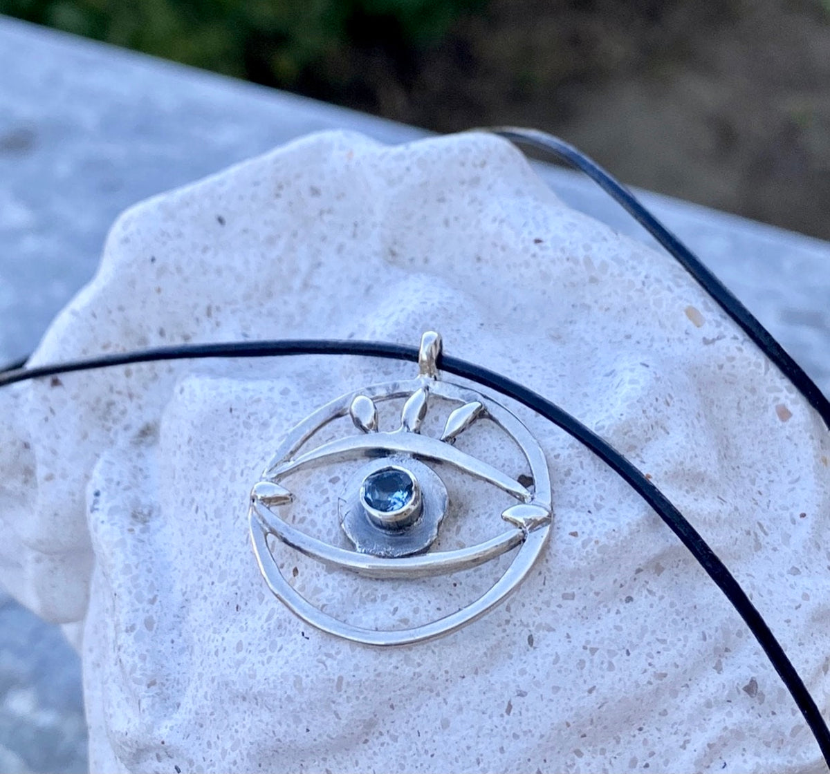 Evil eye necklace with blue gemstone and leather cord