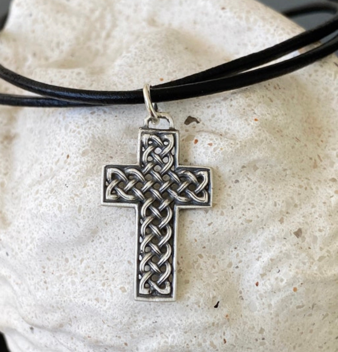 silver Celtic cross with black leather cord