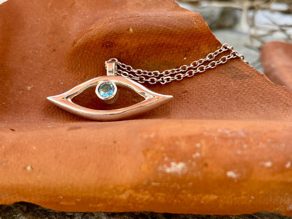 evil eye necklace with blue topaz gemstone