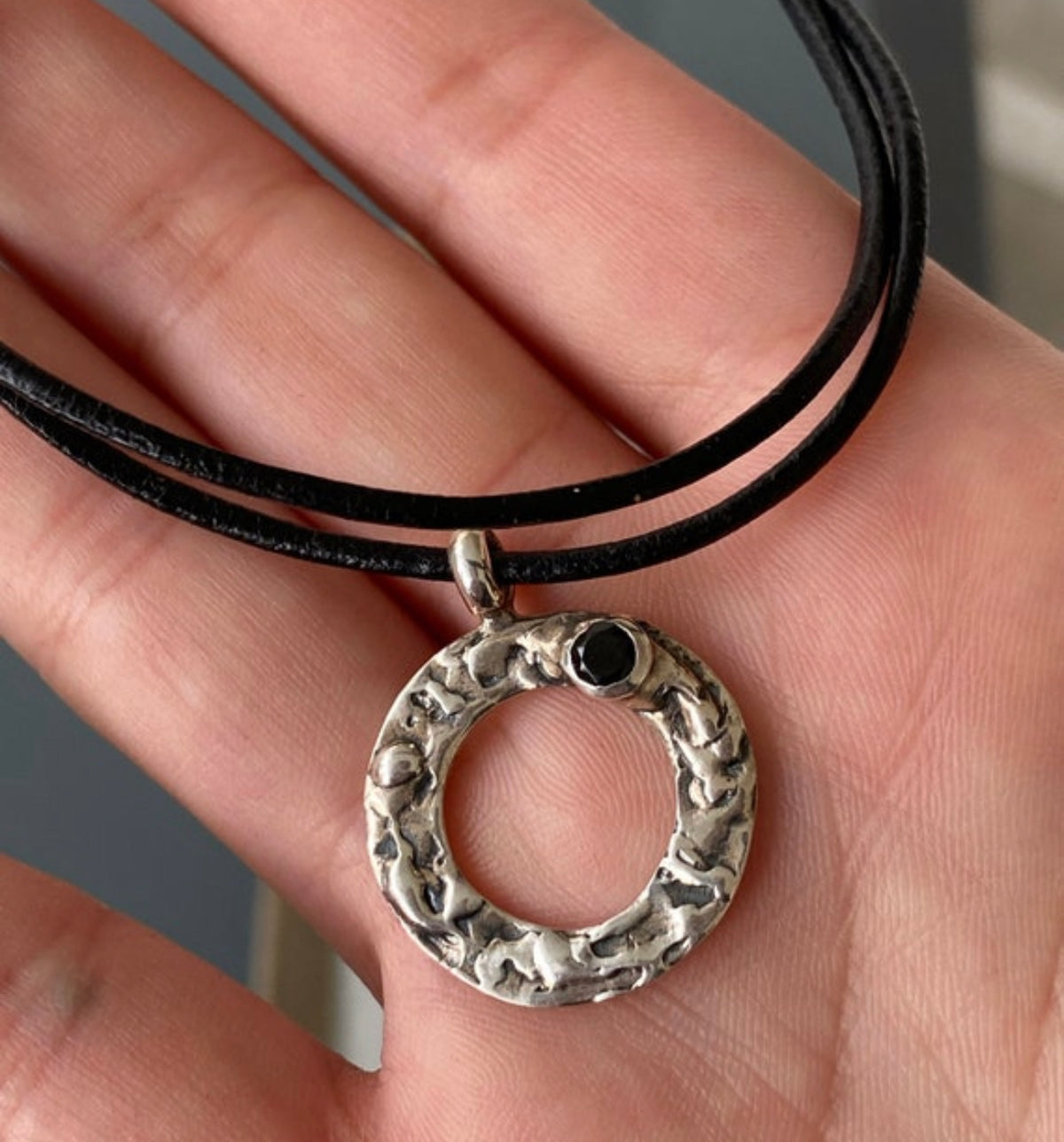 handmade circle necklace with a black gemstone