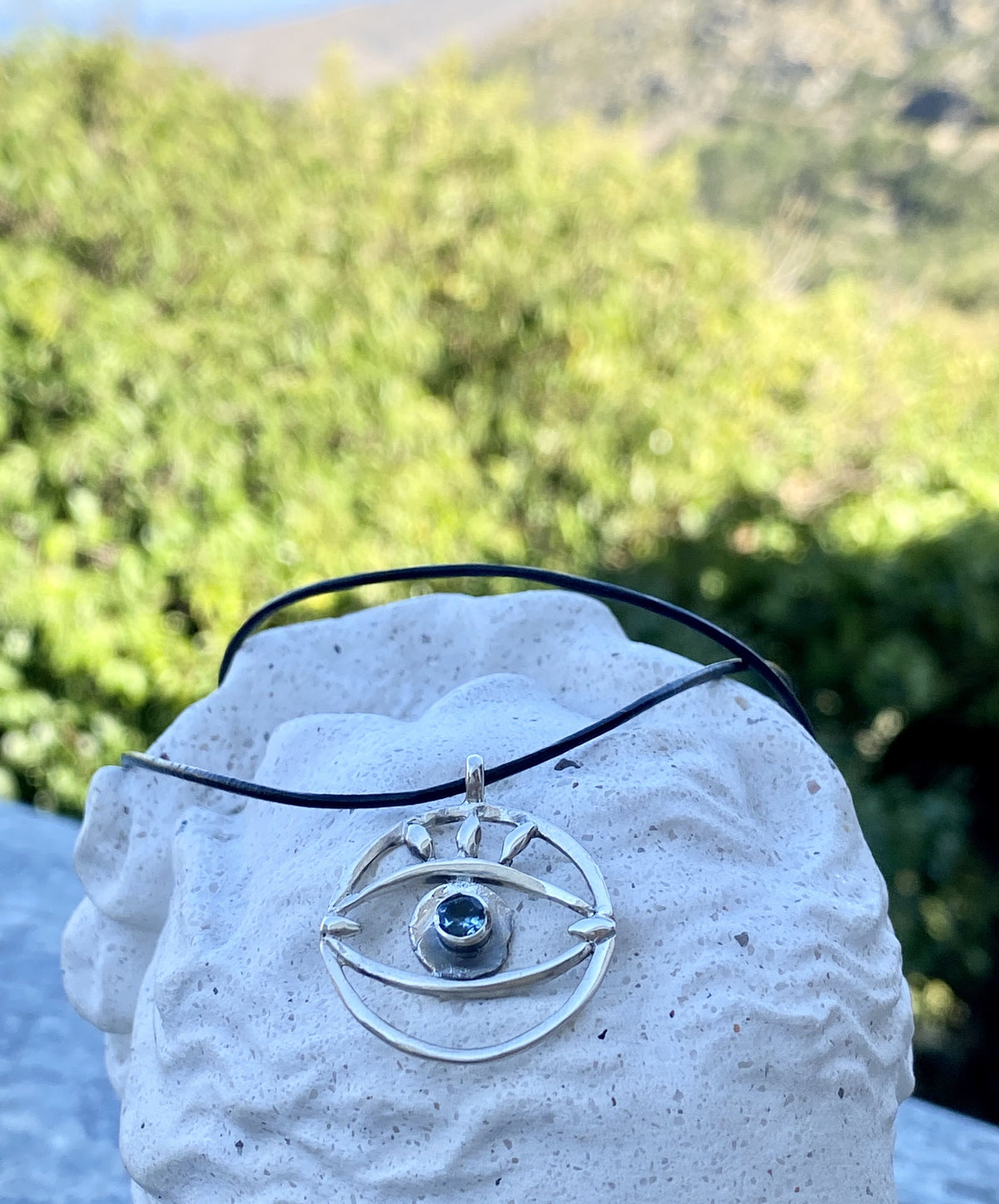 Evil eye necklace with blue gemstone and leather cord