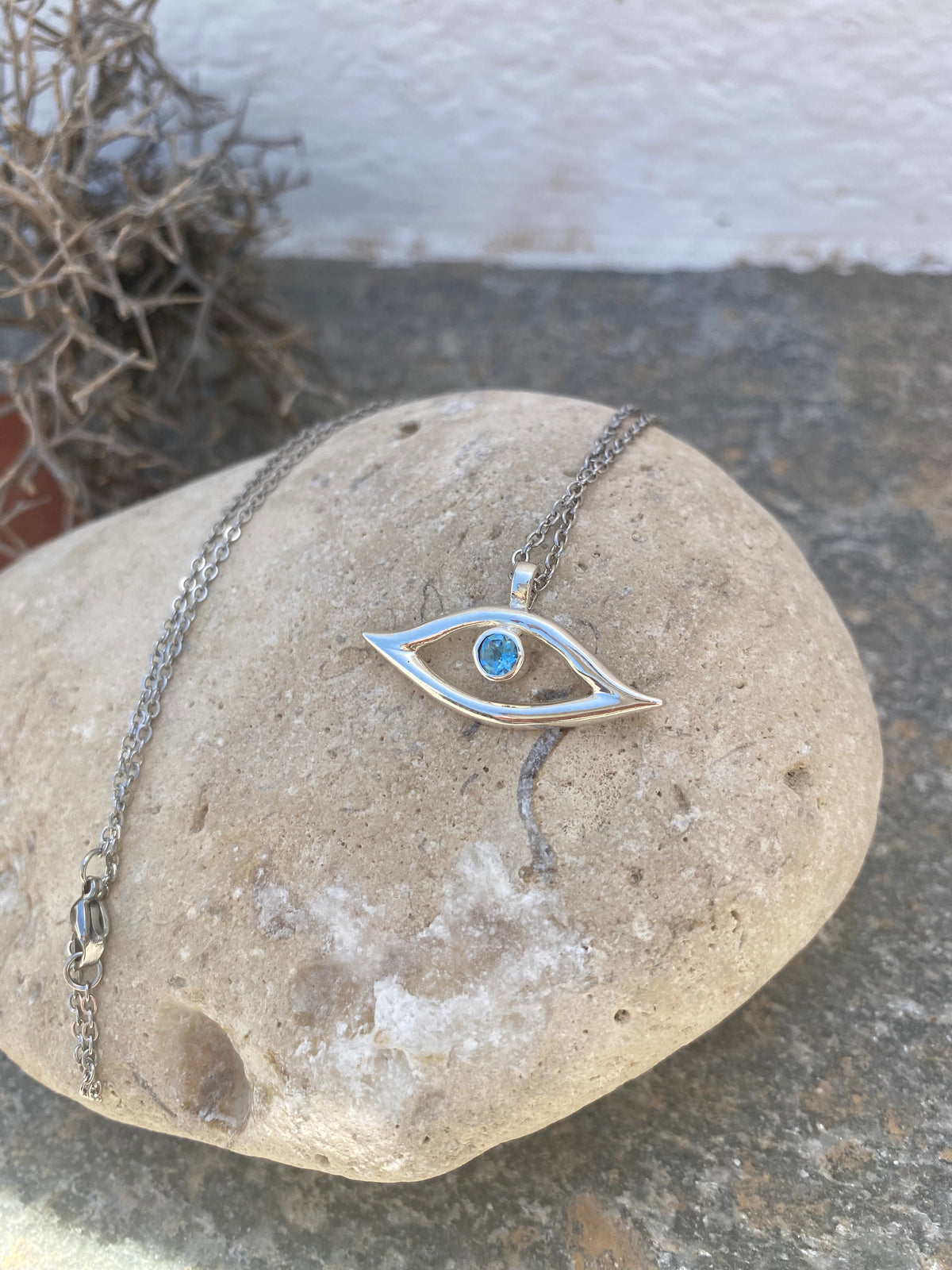 evil eye necklace with blue topaz gemstone