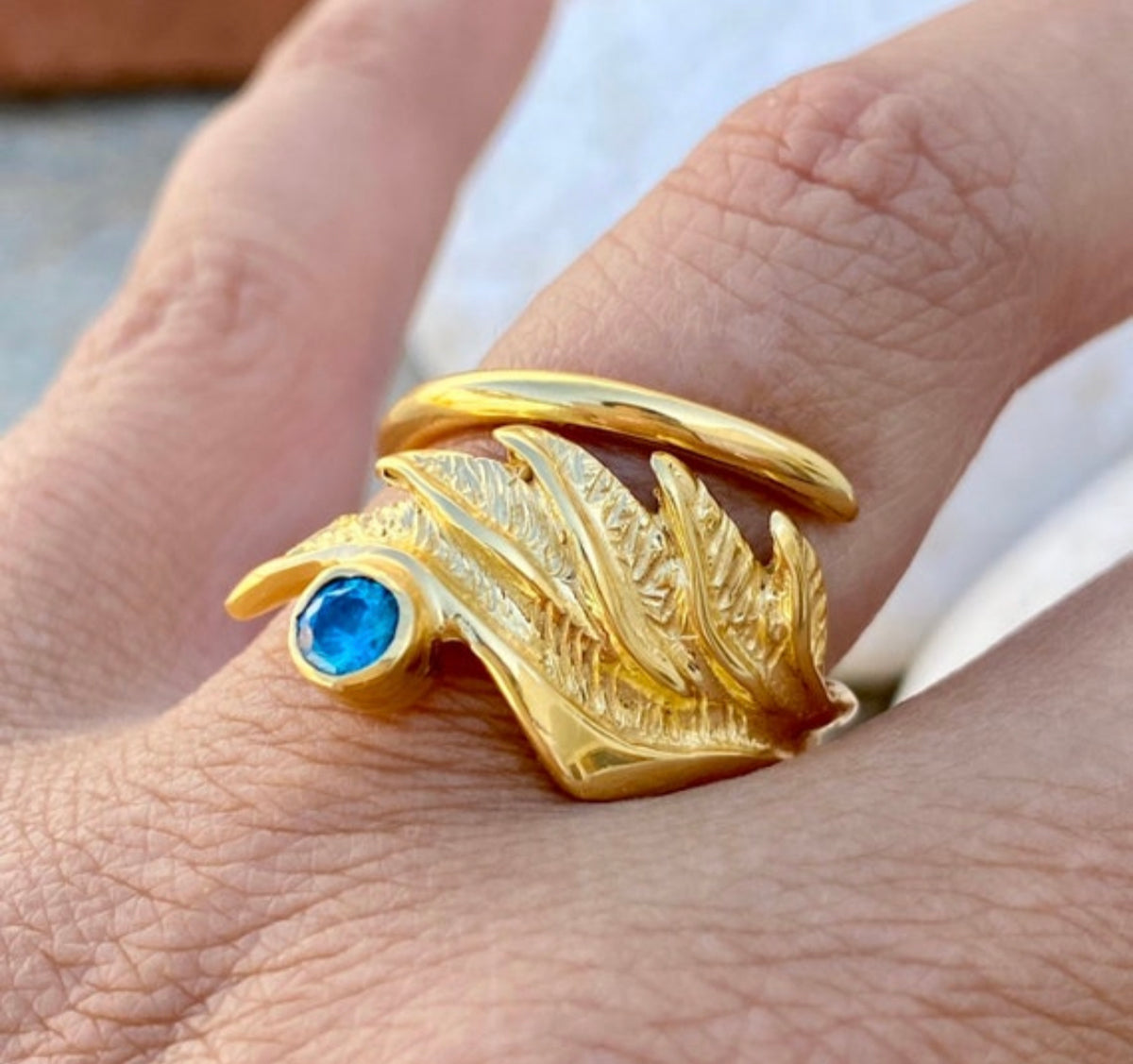 angel wing ring with blue gemstone