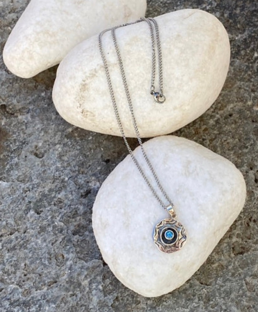 round evil eye necklace with blue topaz