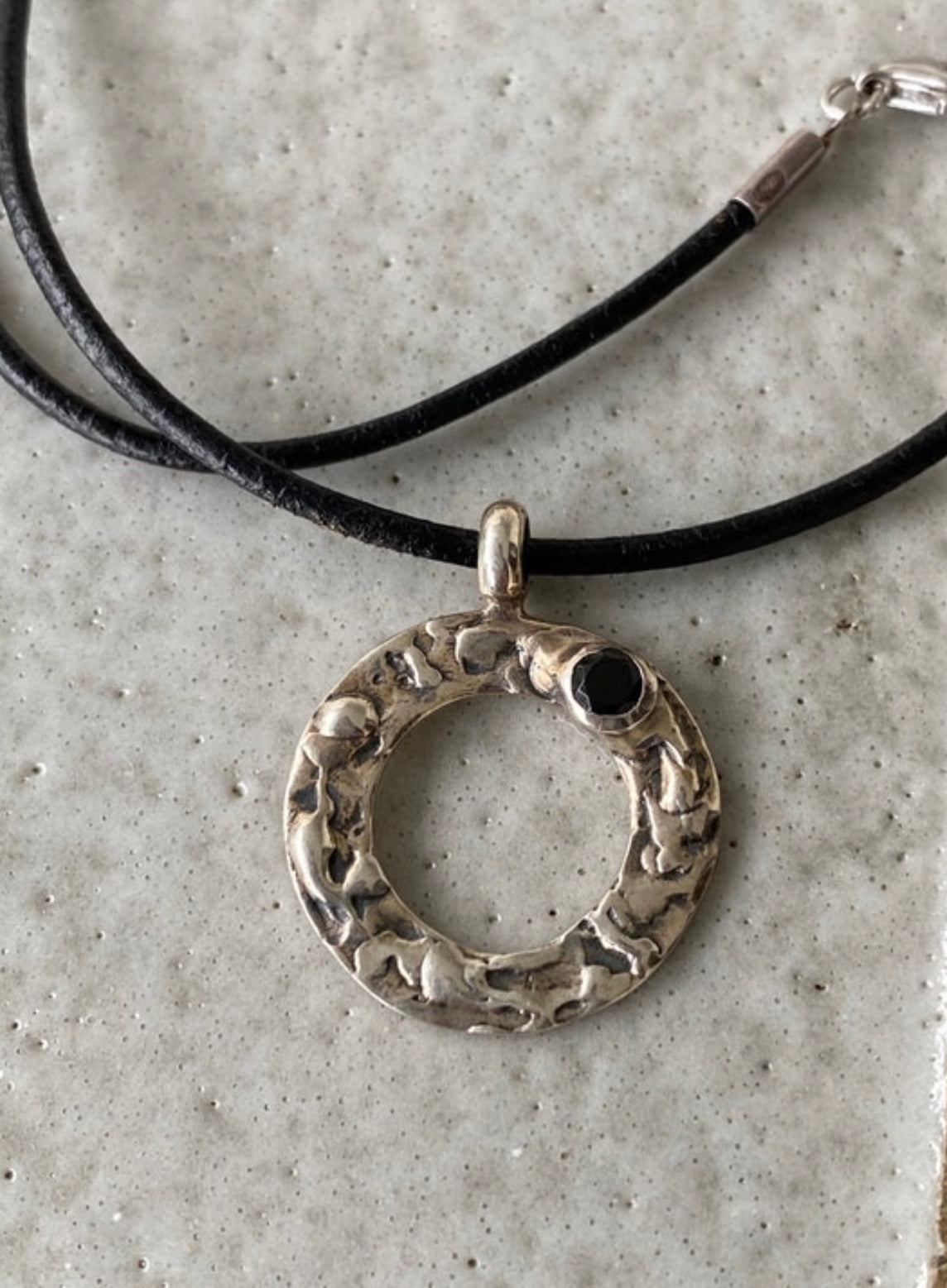 handmade circle necklace with a black gemstone